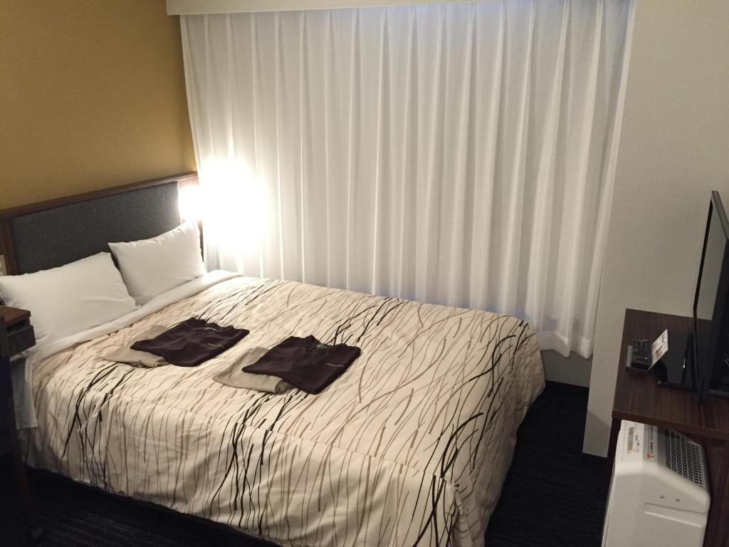 Postel nebo postele na pokoji v ubytování Fukui Manten Hotel Ekimae
