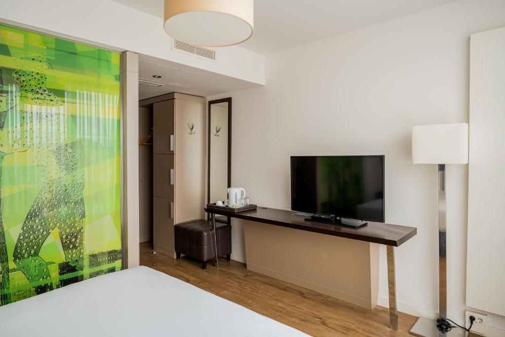 TV a/nebo společenská místnost v ubytování Homaris West Side