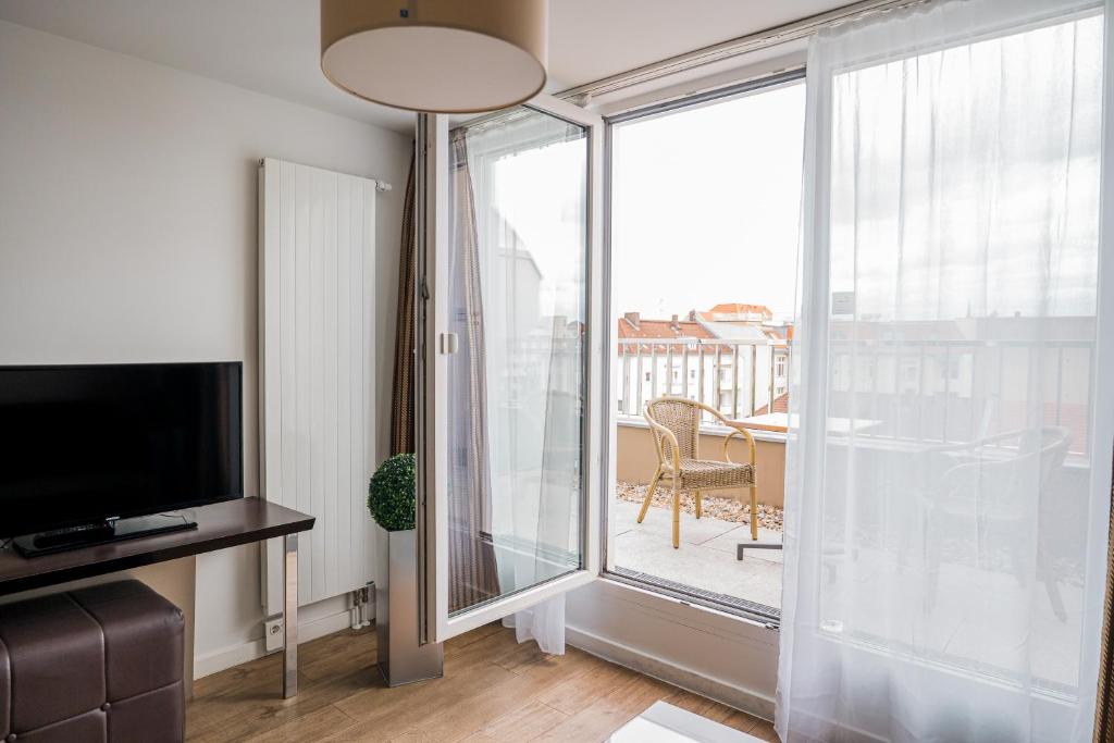 TV a/nebo společenská místnost v ubytování Homaris West Side