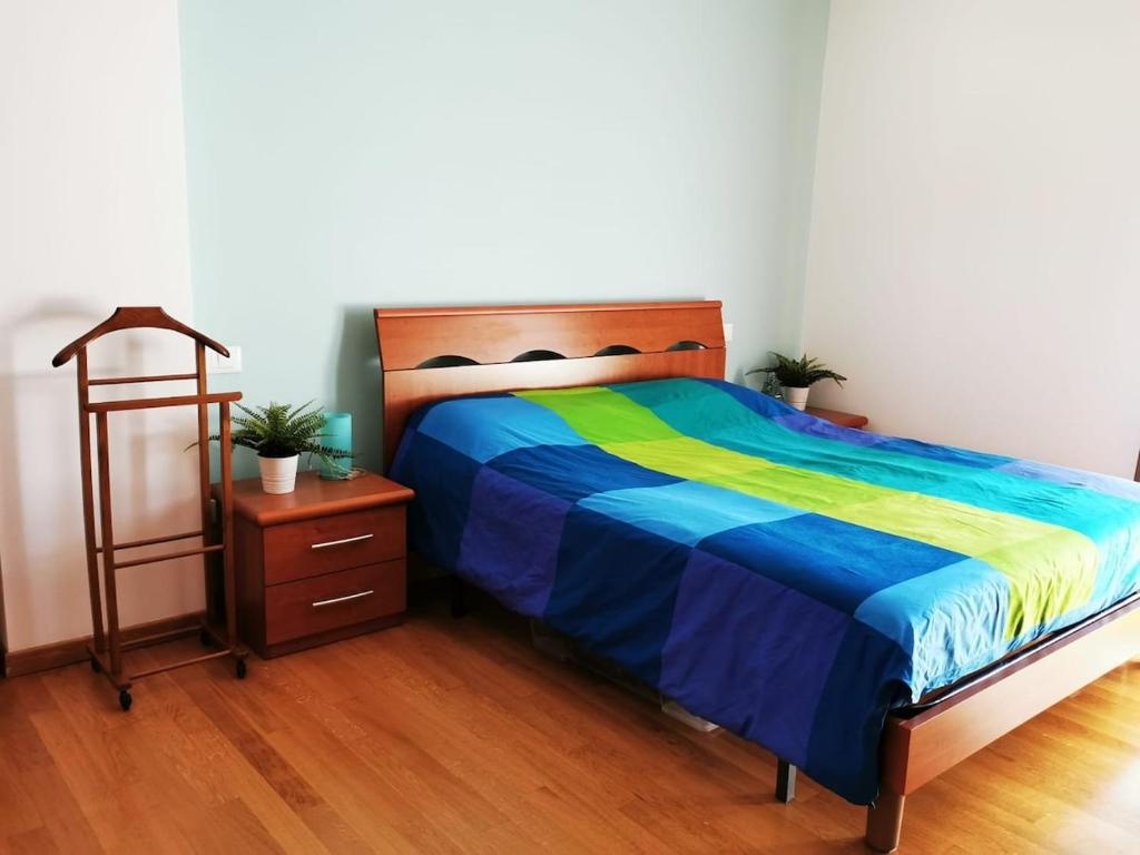 a bedroom with a bed and a dresser with awered at Your retreat in Mestre - Venezia comoda a due passi in Venice