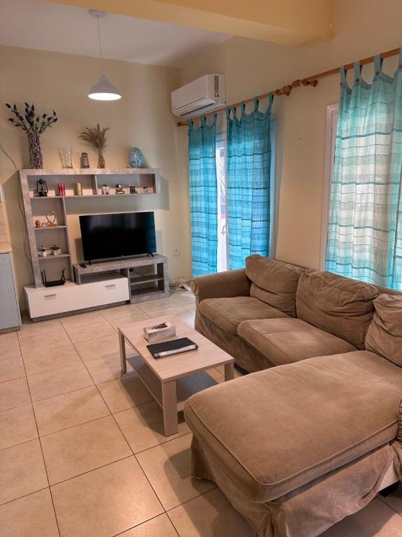 a living room with a couch and a coffee table at Vergi Apartments in Pyla