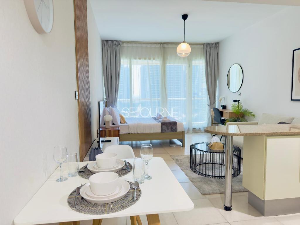 a kitchen and living room with a table and chairs at DA86 - Well Design Studio in Dubai Arch tower in Dubai