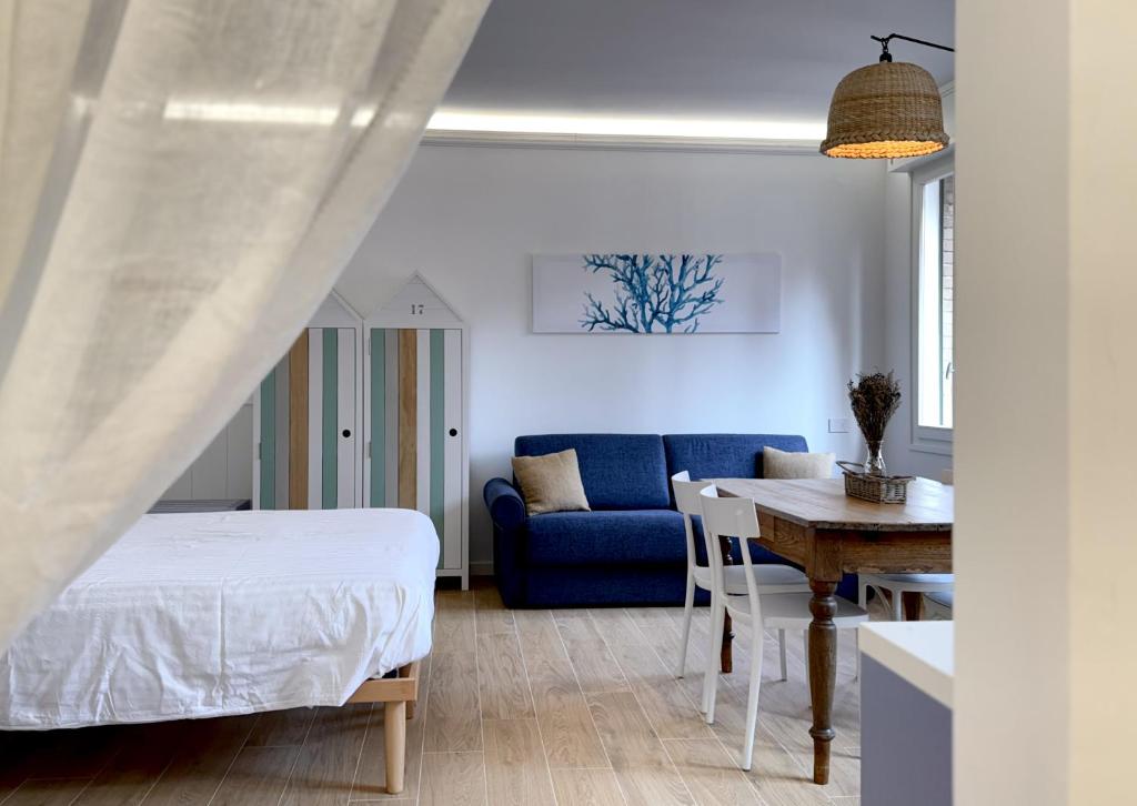 a bedroom with a bed and a table and a couch at Country Rooms Medicina B&B - Free Breakfast - Air Conditioning - WiFi in Medicina