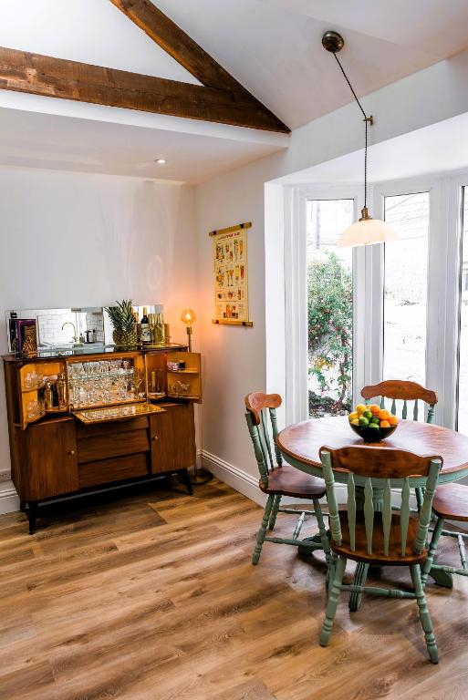 a dining room with a table and chairs at Spacious Victorian 4 Bed l Cocktail Bar Spa Bath Workspaces in Plymouth