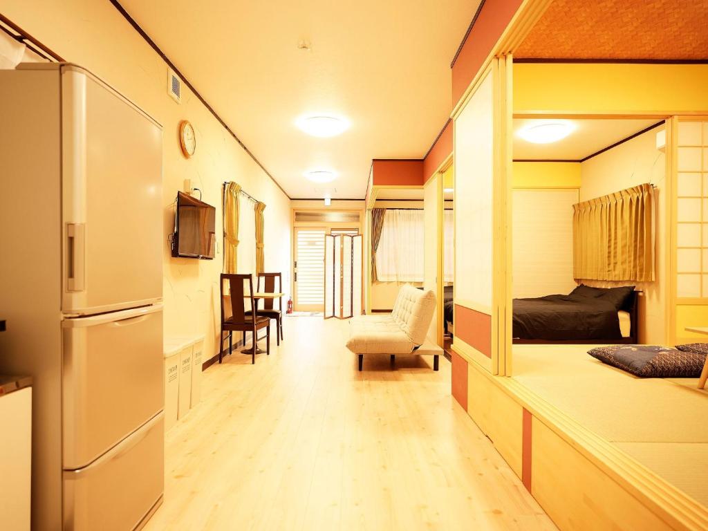 a small room with a kitchen and a bedroom with a refrigerator at Mcity in Maejima - Vacation STAY 54881v in Naha