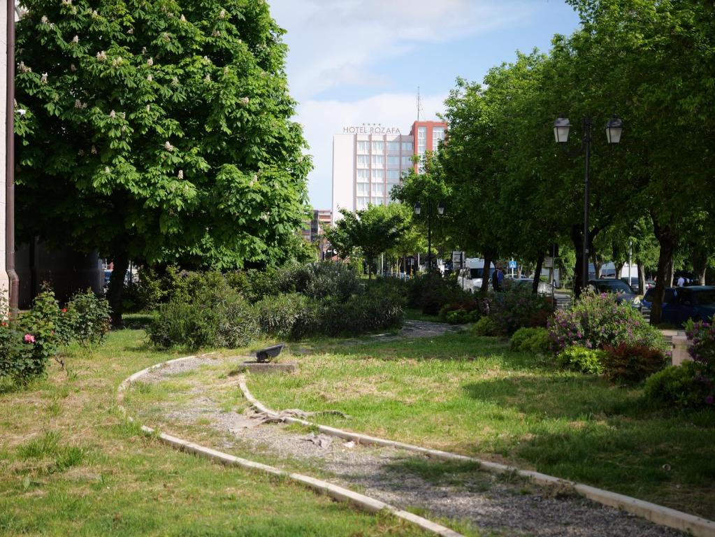 a park with a bird sitting on the grass at Fisi Heritage Home&Apartaments in Shkodër