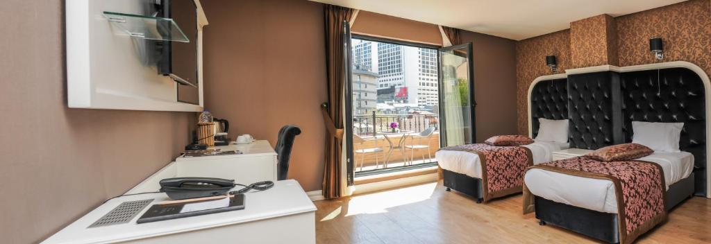 En eller flere senger på et rom på Dencity Hotels & Spa