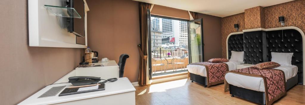 a small room with a bed and a window at Dencity Hotels & Spa in Istanbul