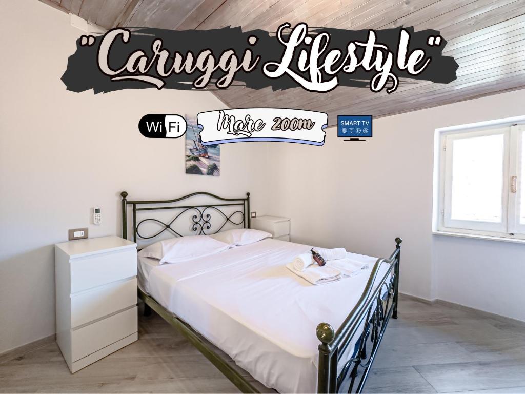 a bedroom with a bed with a sign that reads canyon lifestyle make room at Caruggi Lifestyle - mare 200m - AC - WiFi in Albissola Marina