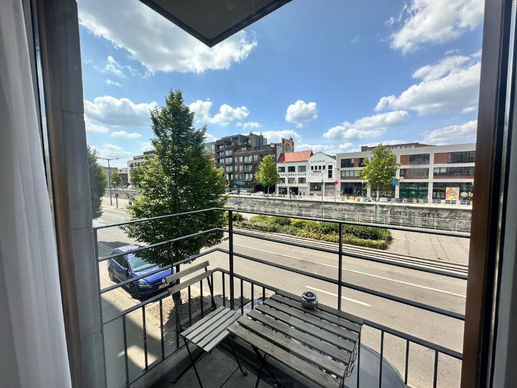 a balcony with a bench and a view of a street at Modern 2 Bedroom Apartment for 6 - City Center in Brussels