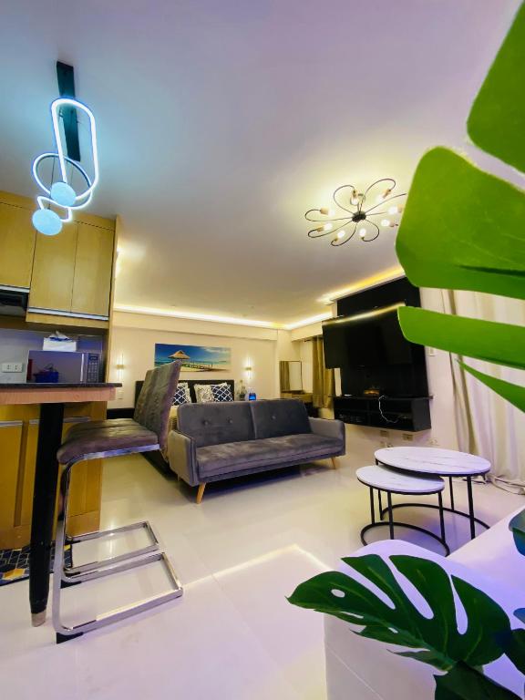 a living room with a couch and a table at Cozy Studio near Airport in Pusok
