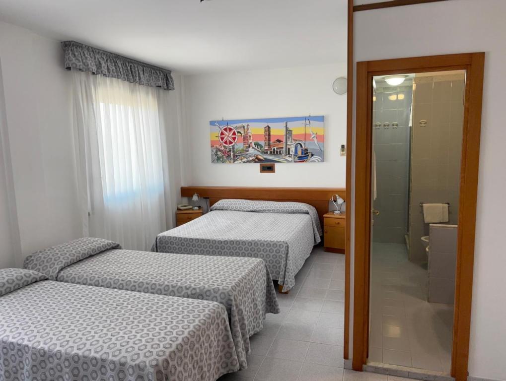 Postel nebo postele na pokoji v ubytování Hotel Le Palme