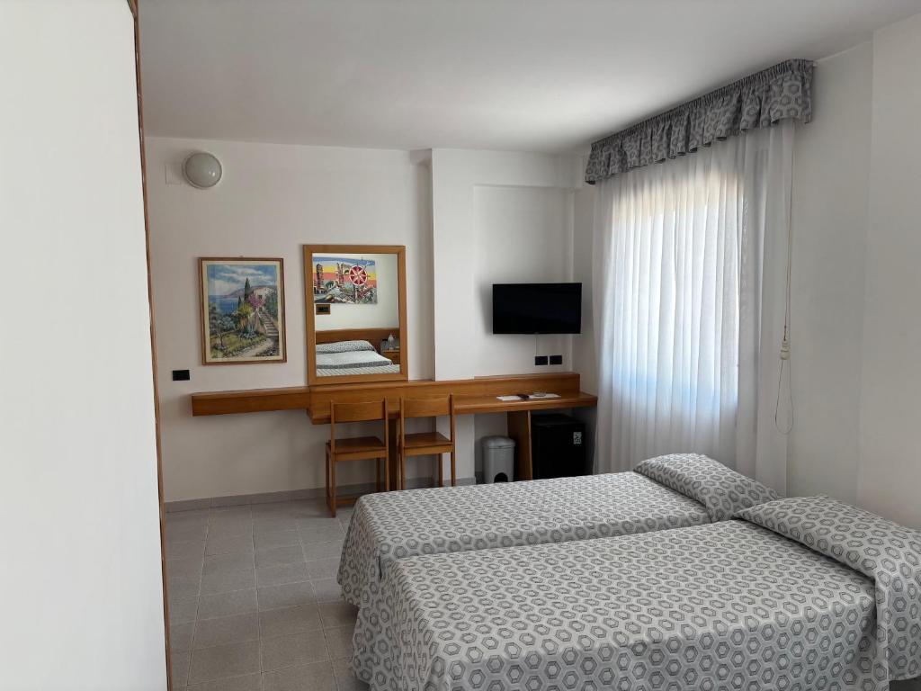 Postel nebo postele na pokoji v ubytování Hotel Le Palme