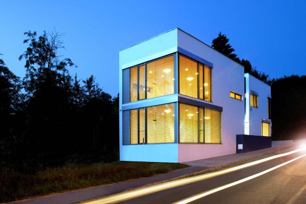 uma casa com grandes janelas do lado de uma rua em Villa Ľadoveň LUXUSNÝ APARTMÁN 124m2 em Martin