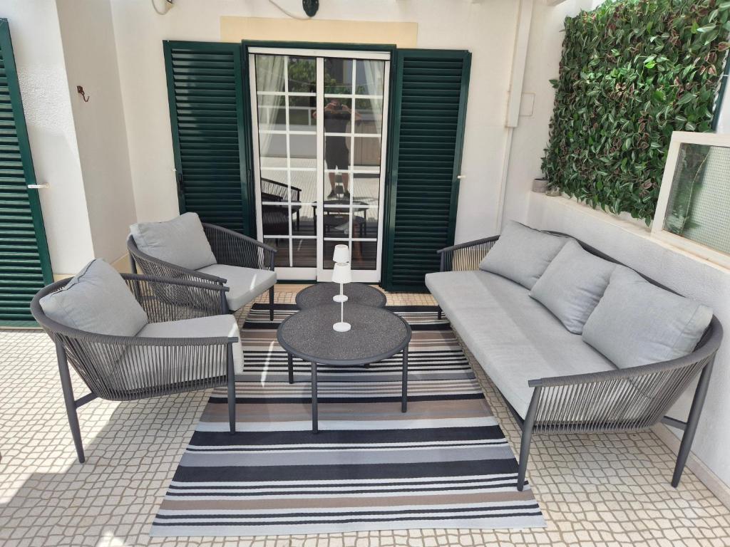 a patio with two chairs and a table on a rug at Manta Azul in Manta Rota
