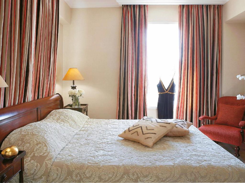 Postel nebo postele na pokoji v ubytování Grecotel Larissa Imperial