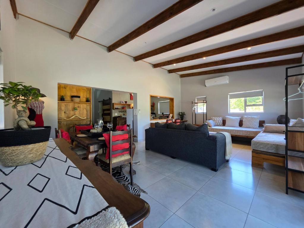 a living room with a couch and a table at Ukulala Inn in Malelane