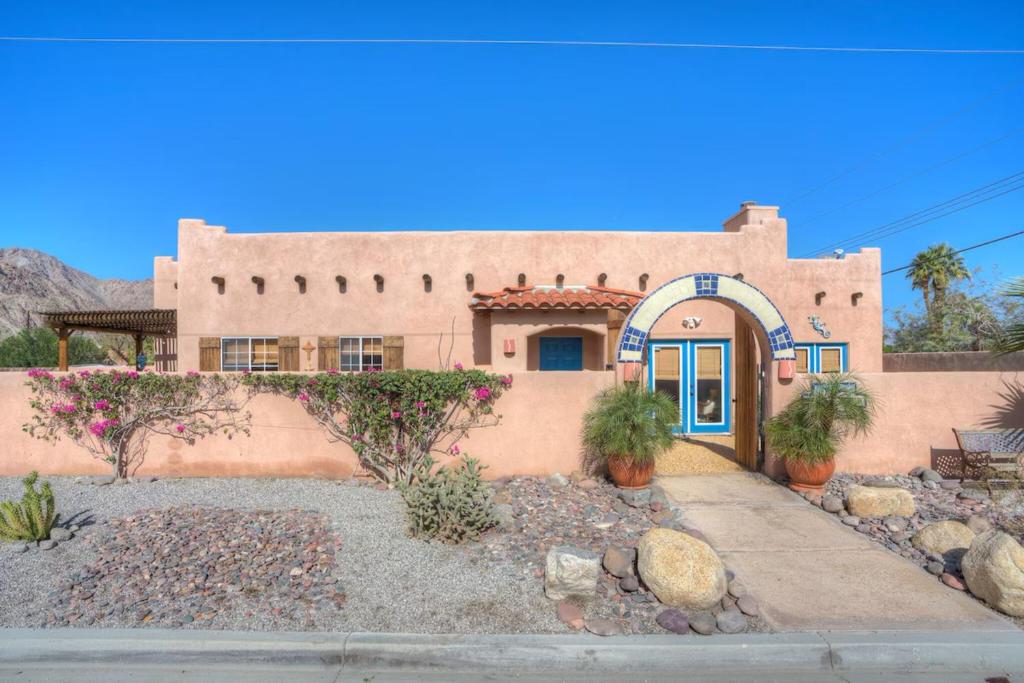 a house with a blue door in front of it at Villa Escondida in La Quinta