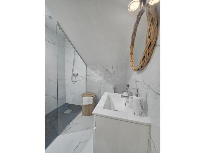 a white bathroom with a sink and a shower at Cris Place in Câmara de Lobos