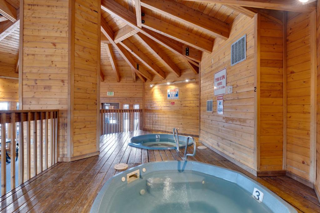 a jacuzzi tub in a room with wooden walls at Tyra Stream 234 by Ski Country Resorts in Breckenridge