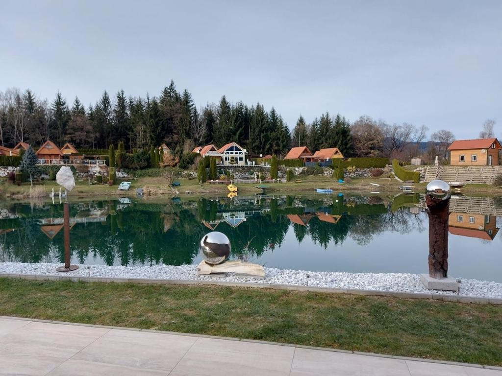 a pond with a statue of a person sitting in front of it at Villa Gloria Spielberg in Spielberg