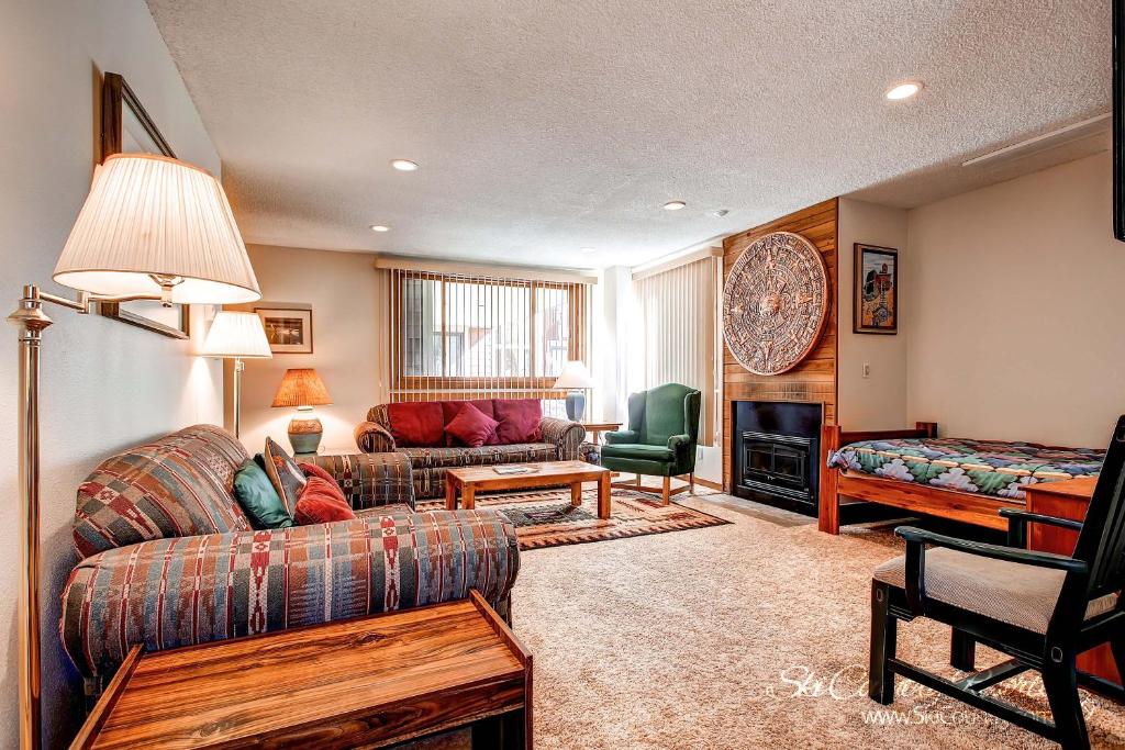 a living room with a couch and a chair at Ski Hill 15 by Ski Country Resorts in Breckenridge