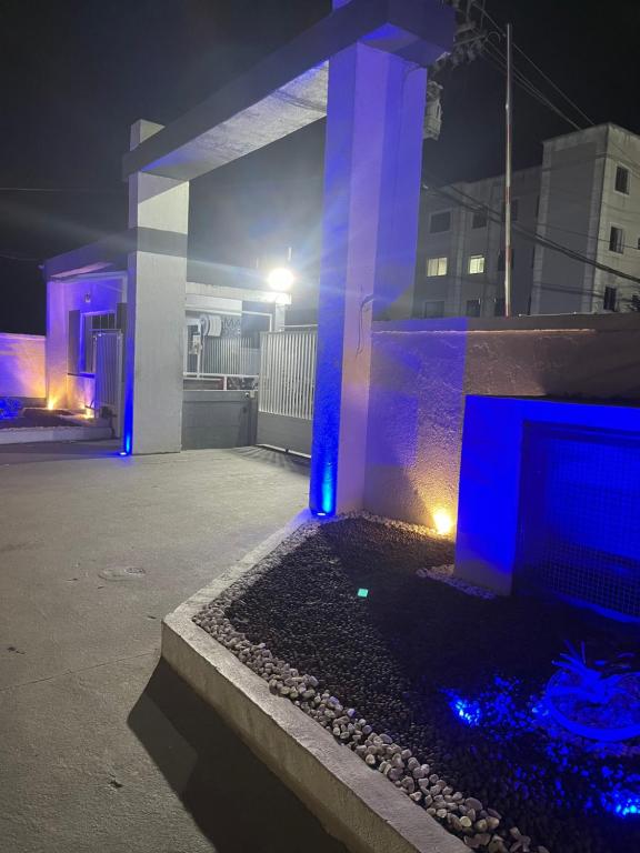 a house with blue lights on it at night at Apartamento condomínio maré d oro in Rio das Ostras