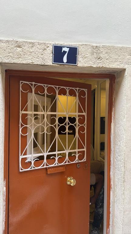 a door with a sign on it with a sign above it at Suite - Centro histórico Mouraria in Lisbon
