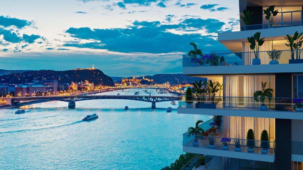 a view of a river with a bridge and buildings at INFINITY Budapest Hotel - Adults Only in Budapest