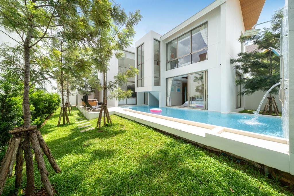 an exterior view of a house with a swimming pool at Sofia Villa Phuket in Phuket Town