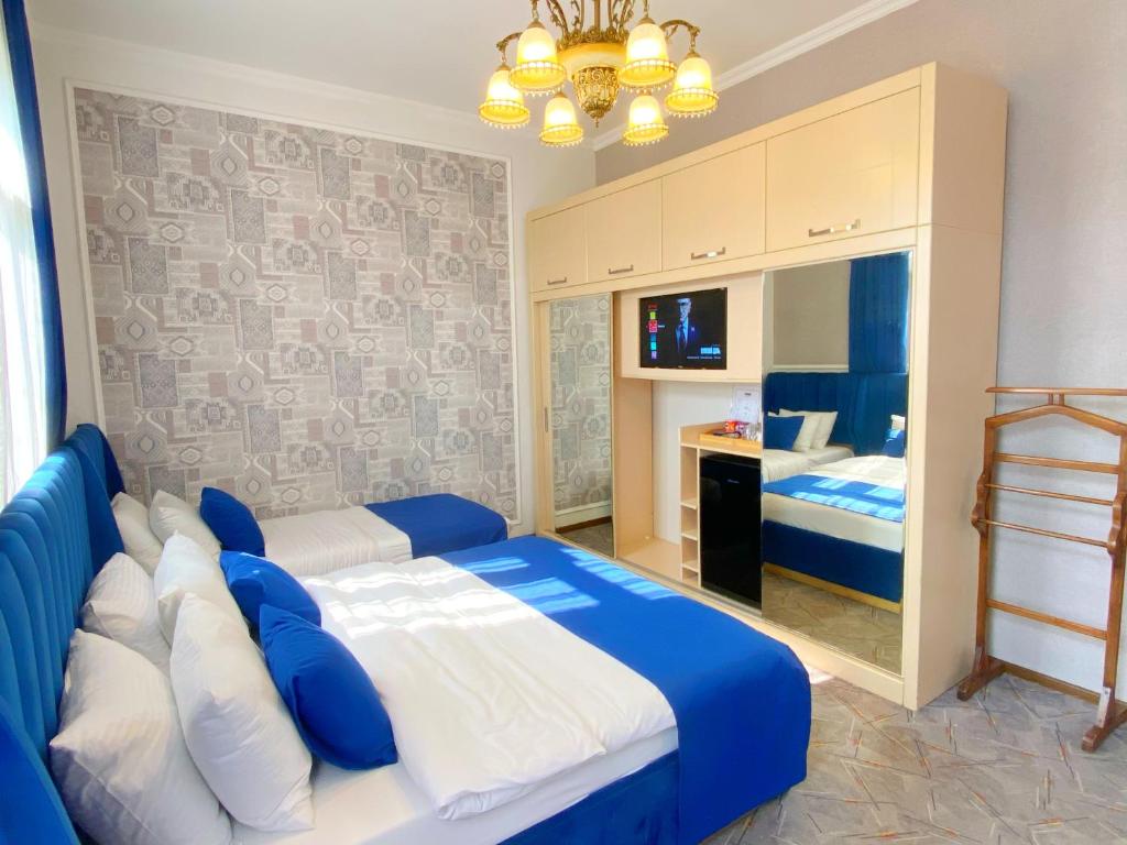 Postel nebo postele na pokoji v ubytování Hotel Orange Kutaisi