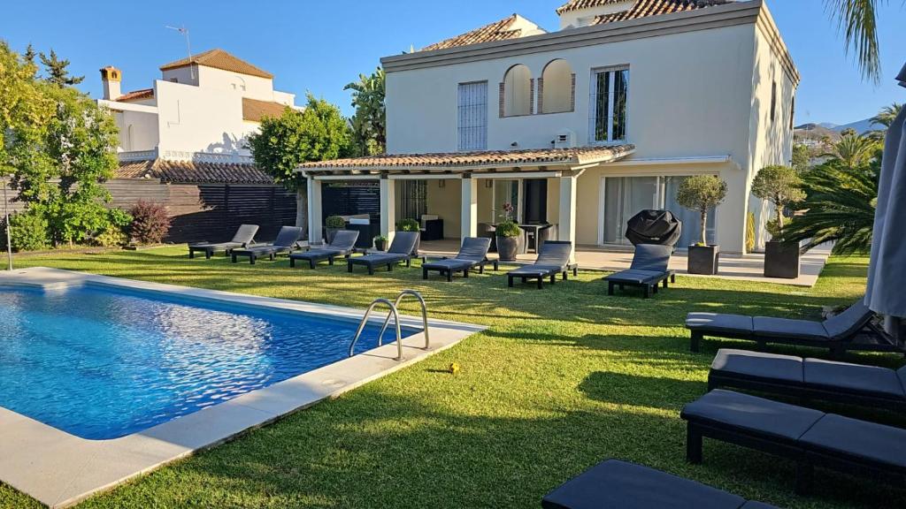 a house with a swimming pool in the yard at Stunning 5 Bedroom Villa in Puerto Banus with Pool in Marbella