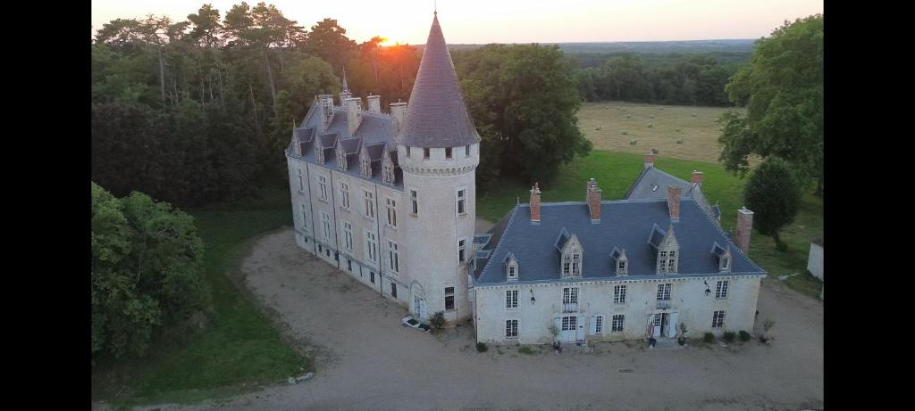 an aerial view of a castle with a tower at Les chambres du Chateau de Farge-Allichamps in Farges-Allichamps