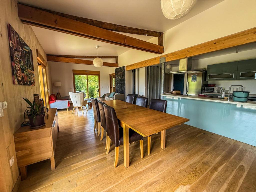 a kitchen and dining room with a wooden table and chairs at Gîte Domaine Taureau in Saint-Brisson