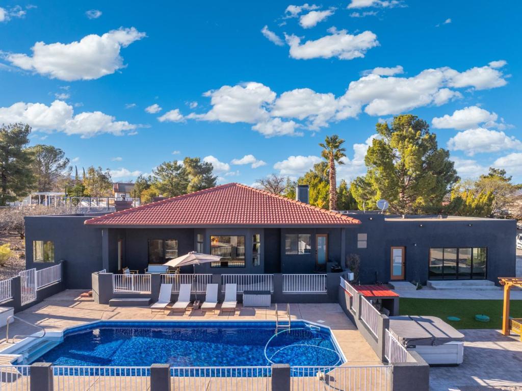 a home with a swimming pool and a house at Luxury 5BR Cottonwood Retreat with Pool and Panoramic Views in Cottonwood