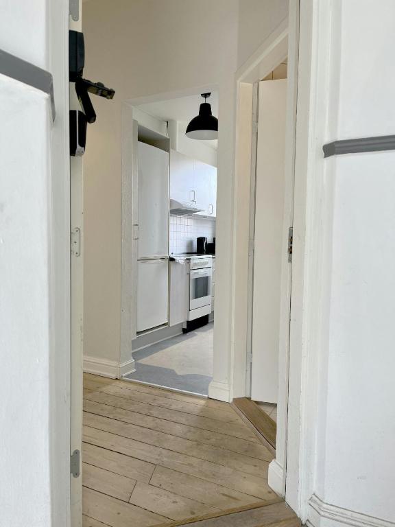 an empty room with a hallway with a kitchen at Spacious Apartment for 6 in Frederikshavn
