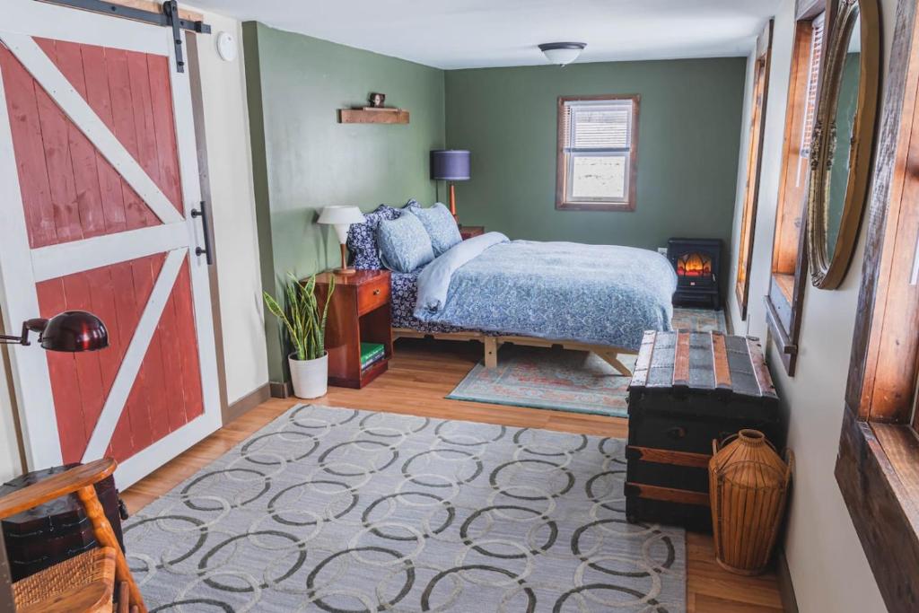 a bedroom with a bed and a barn door at Historic Farmhouse Apartment 