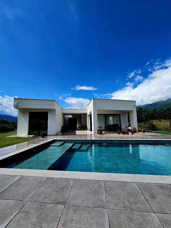 a large swimming pool in front of a house at Villa Bellevue in Mostar