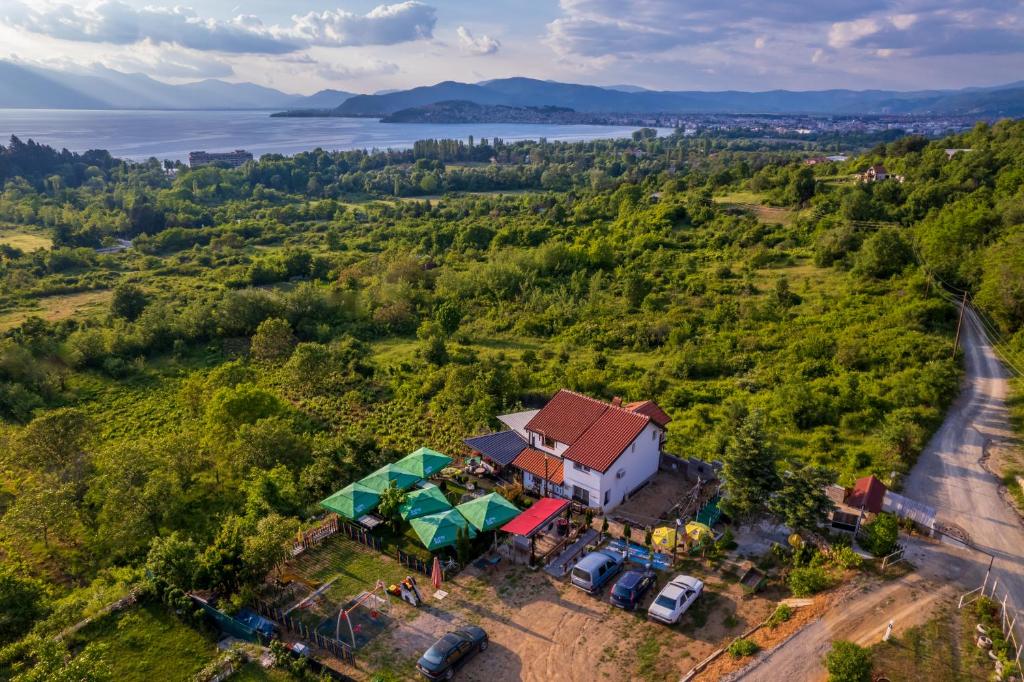 an aerial view of a house on a hill with a lake at Etno Gostilnica Villa Fulko in Ohrid