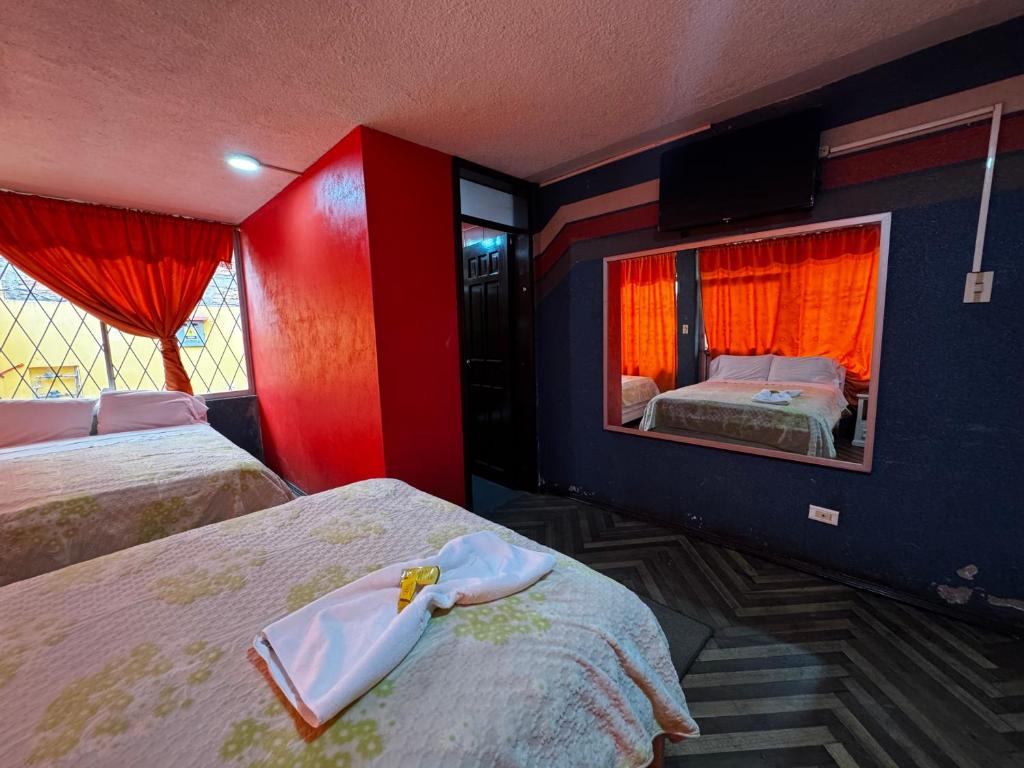 Postel nebo postele na pokoji v ubytování Hotel Jimmy Latacunga