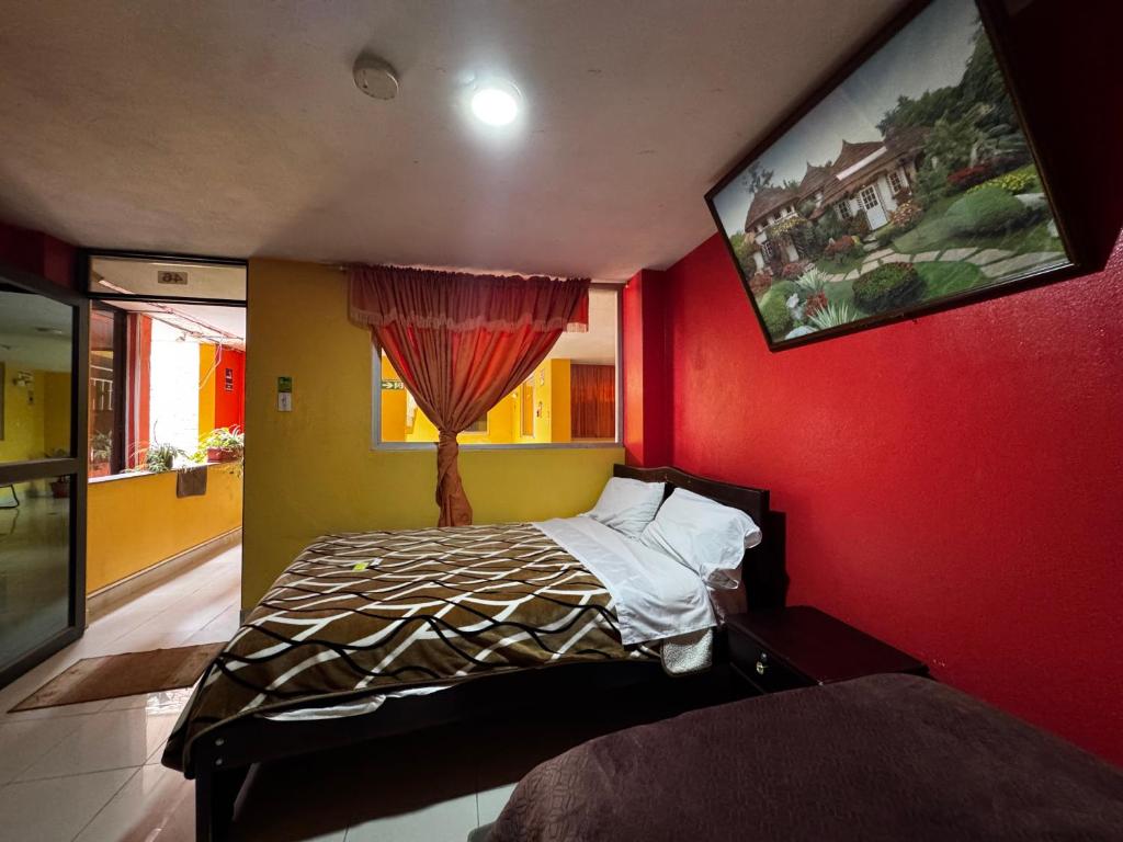 Postel nebo postele na pokoji v ubytování Hotel Jimmy Latacunga