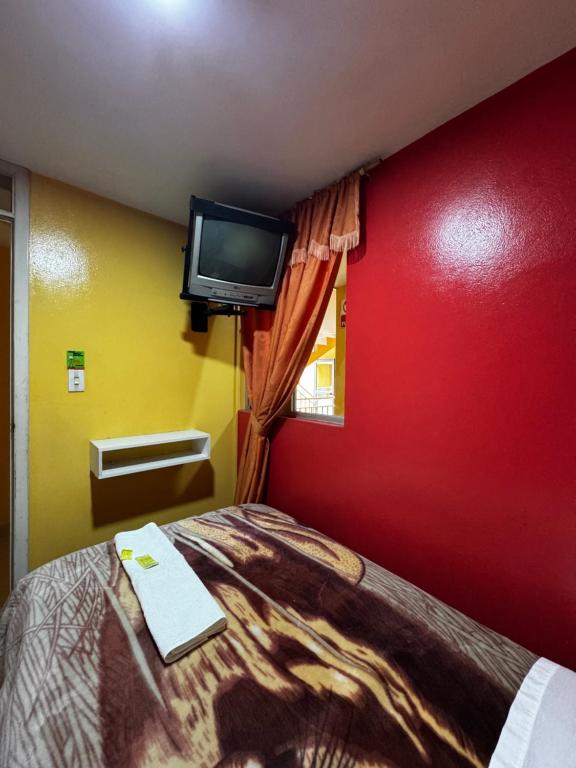 Postel nebo postele na pokoji v ubytování Hotel Jimmy Latacunga