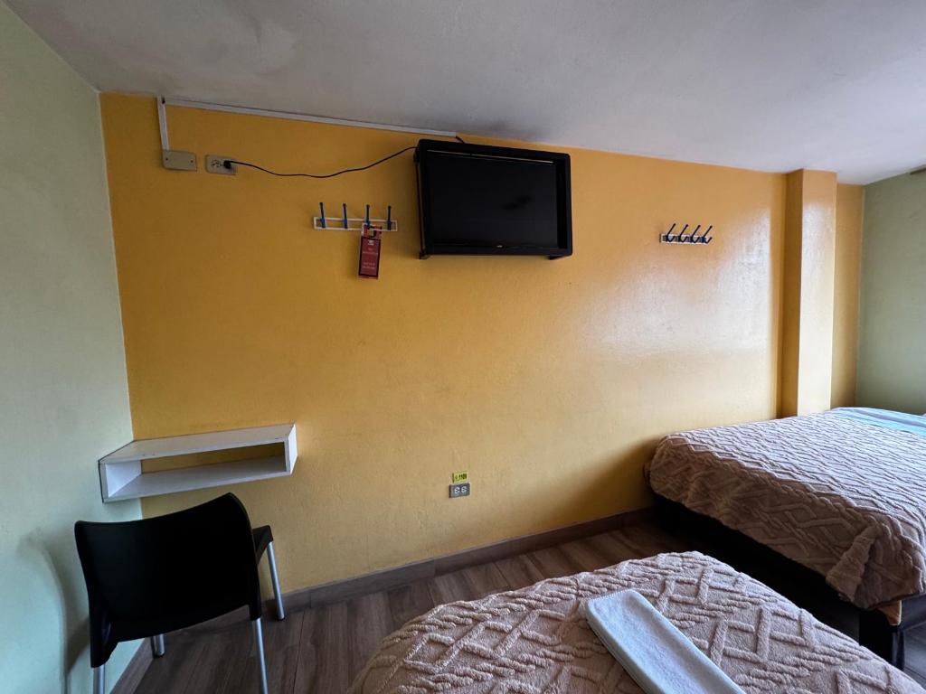 Postel nebo postele na pokoji v ubytování Hotel Jimmy Latacunga