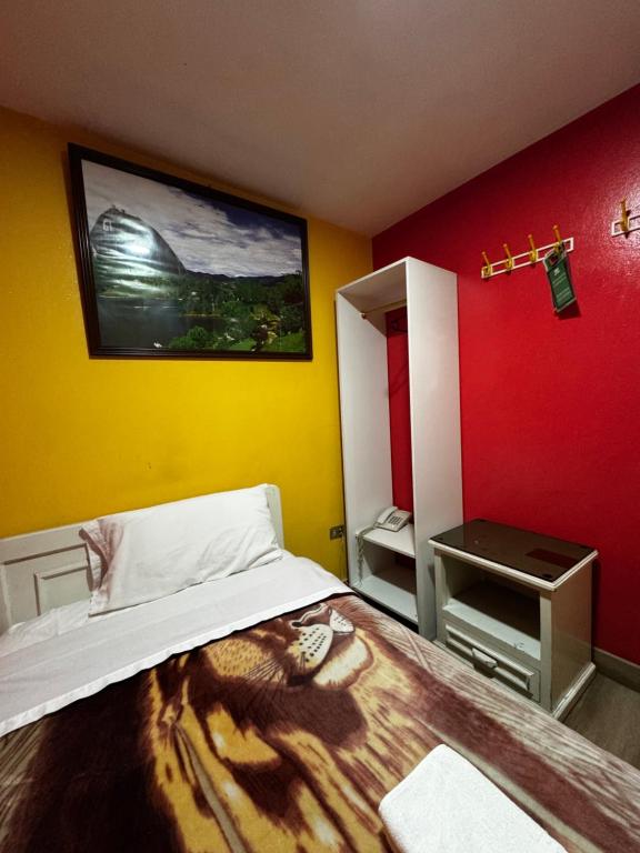 Postel nebo postele na pokoji v ubytování Hotel Jimmy Latacunga