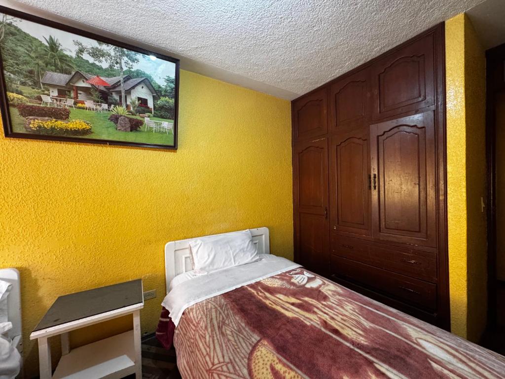 Postel nebo postele na pokoji v ubytování Hotel Jimmy Latacunga