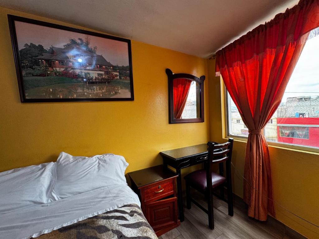 Postel nebo postele na pokoji v ubytování Hotel Jimmy Latacunga