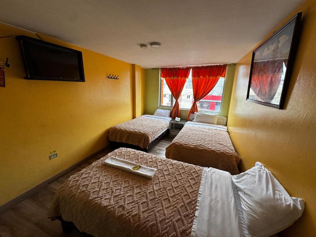 Postel nebo postele na pokoji v ubytování Hotel Jimmy Latacunga
