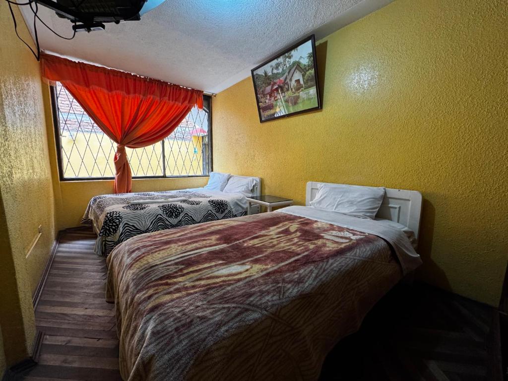 Postel nebo postele na pokoji v ubytování Hotel Jimmy Latacunga
