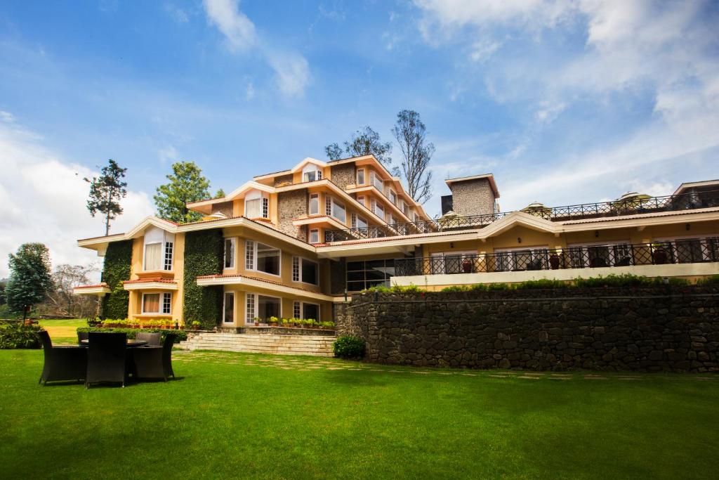 a large house with a lawn in front of it at The Carlton Kodaikanal in Kodaikānāl