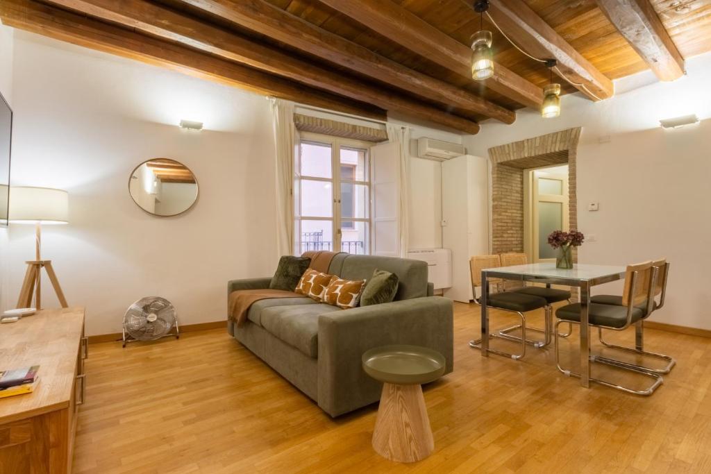 a living room with a couch and a table at Martini Castello Boutique Apartments - Historic Center & Lift in Cagliari